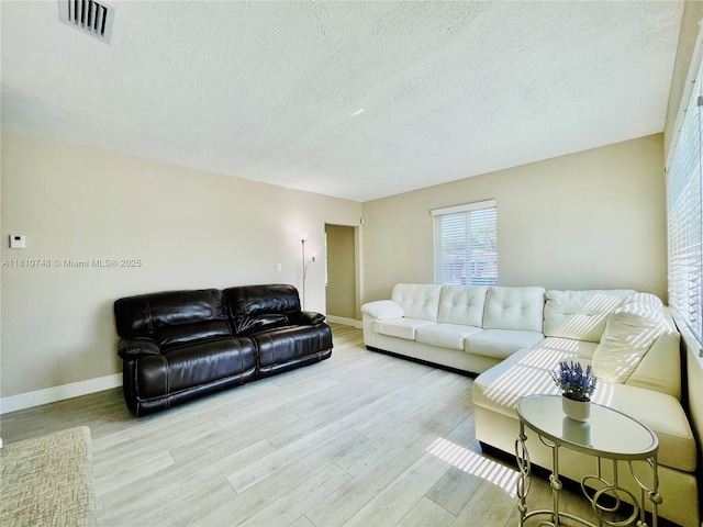 1002 S 27th Ave, Hollywood, FL 33020 - living room with wood finished floors, baseboards, and a textured ceiling