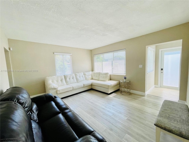 1002 S 27th Ave, Hollywood, FL 33020 - living room with light wood-style floors, baseboards, and a textured ceiling