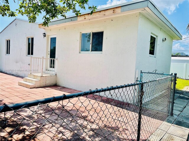 1002 S 27th Ave, Hollywood, FL 33020 - back of property featuring stucco siding, a patio, and a gate