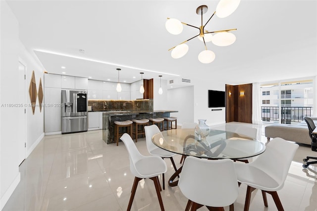 1501 S Ocean Dr Unit 1005, Hollywood, FL 33019 - dining area with a chandelier, baseboards, light tile patterned floors, and recessed lighting
