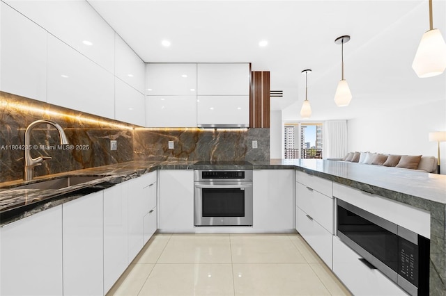 1501 S Ocean Dr Unit 1005, Hollywood, FL 33019 - kitchen with stainless steel appliances, modern cabinets, white cabinets, a sink, and recessed lighting