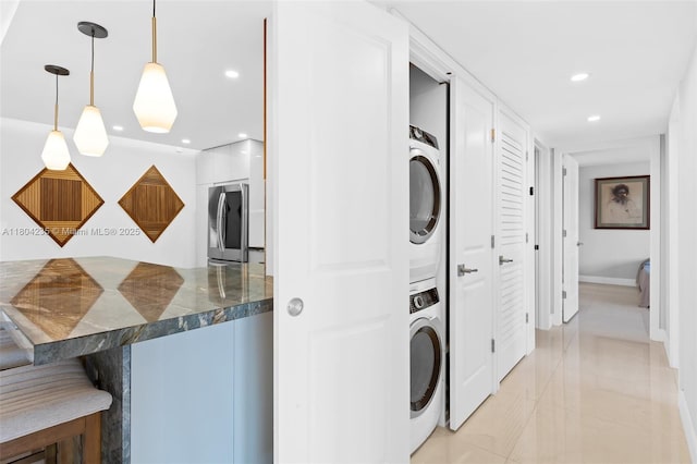 1501 S Ocean Dr Unit 1005, Hollywood, FL 33019 - laundry room with stacked washer / drying machine, light tile patterned flooring, recessed lighting, and baseboards
