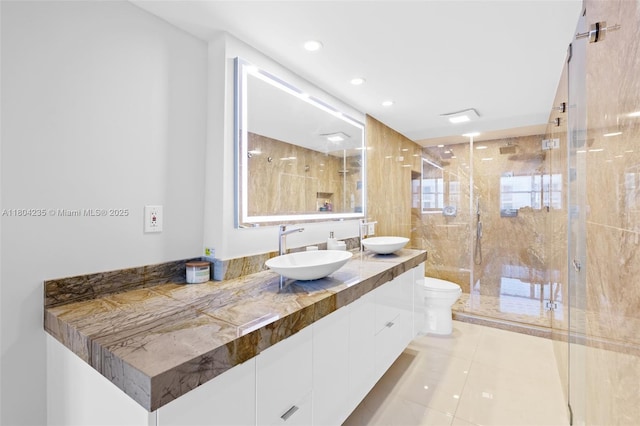 1501 S Ocean Dr Unit 1005, Hollywood, FL 33019 - full bath featuring double vanity, toilet, a shower stall, tile patterned floors, and recessed lighting