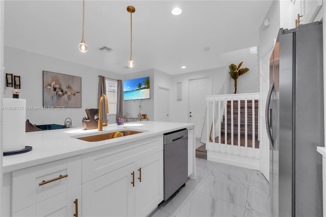 1901 SW 60th Ter, North Lauderdale, FL 33068 - kitchen featuring appliances with stainless steel finishes, a sink, light marble finish flooring, white cabinetry, and hanging light fixtures