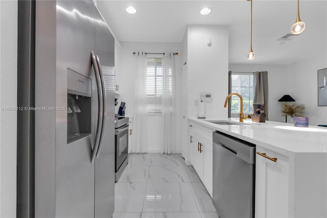 1901 SW 60th Ter, North Lauderdale, FL 33068 - kitchen with appliances with stainless steel finishes, light marble finish floors, a peninsula, plenty of natural light, and recessed lighting