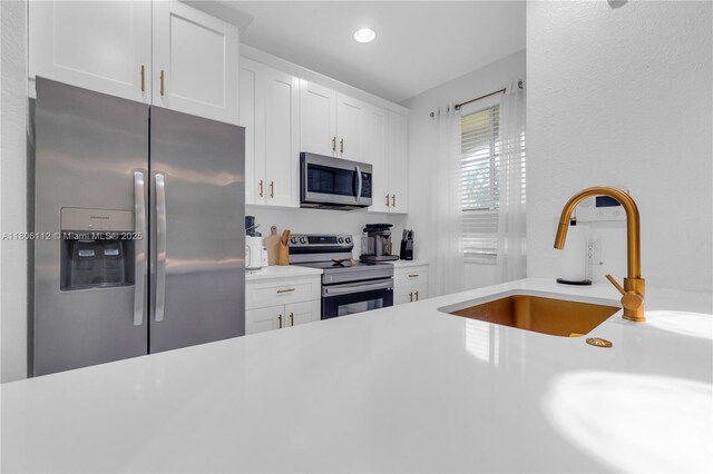 1901 SW 60th Ter, North Lauderdale, FL 33068 - kitchen with stainless steel appliances, light countertops, white cabinets, and recessed lighting