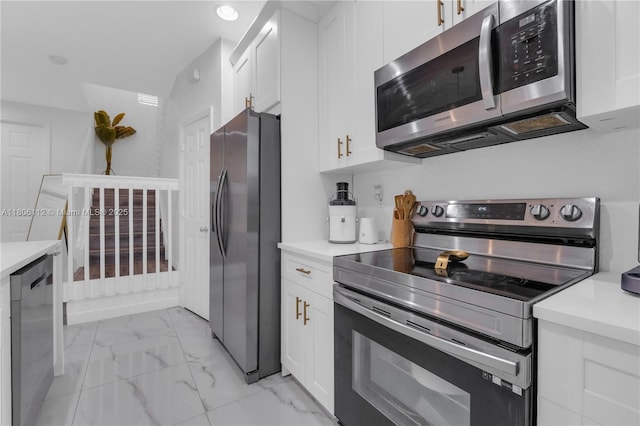 1901 SW 60th Ter, North Lauderdale, FL 33068 - kitchen featuring appliances with stainless steel finishes, white cabinets, light marble finish floors, and light countertops