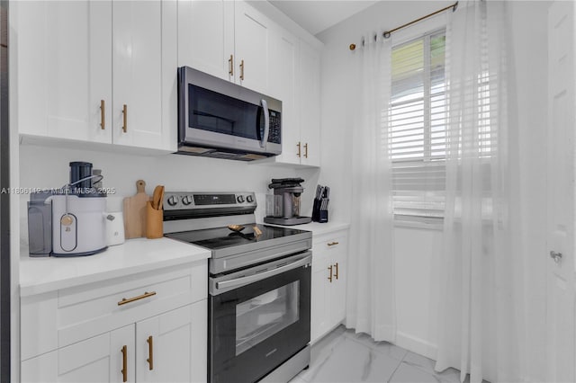 1901 SW 60th Ter, North Lauderdale, FL 33068 - kitchen featuring stainless steel appliances, white cabinets, light marble finish flooring, and healthy amount of natural light