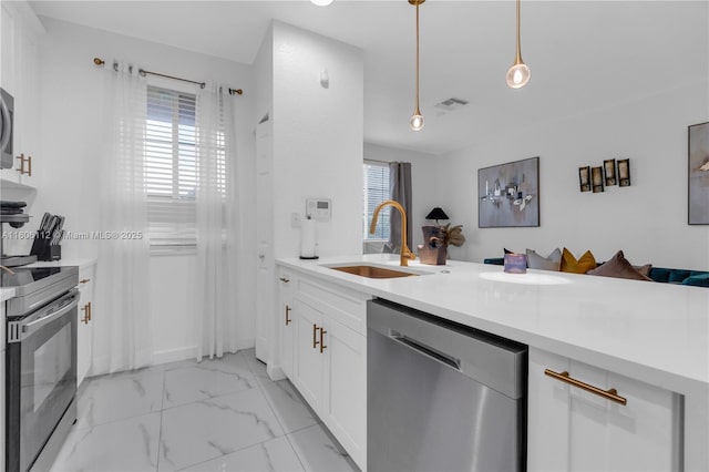 1901 SW 60th Ter, North Lauderdale, FL 33068 - kitchen with dishwasher, a sink, range with electric stovetop, white cabinetry, and light countertops