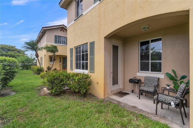 1901 SW 60th Ter, North Lauderdale, FL 33068 - doorway to property with stucco siding, a lawn, and a patio area
