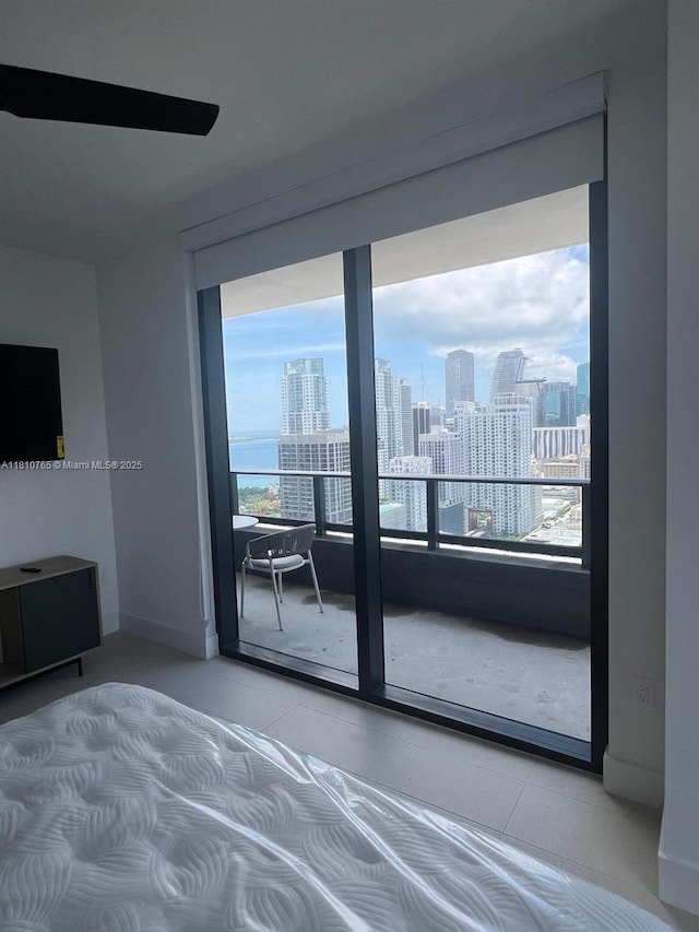601 NE 1st Ave Unit 3205, Miami, FL 33132 - bedroom featuring a view of skyline, tile patterned flooring, and baseboards