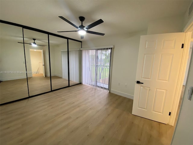 120 Heritage Way, West Palm Beach, FL 33407 - unfurnished bedroom with light wood-type flooring, baseboards, a ceiling fan, and a closet