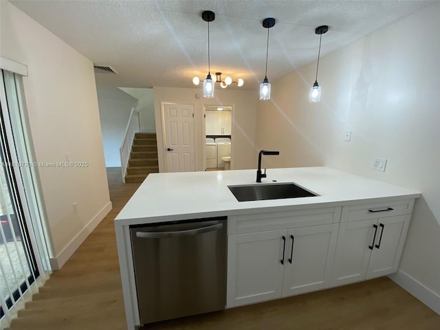 120 Heritage Way, West Palm Beach, FL 33407 - kitchen featuring stainless steel dishwasher, a sink, a peninsula, baseboards, and light wood-type flooring