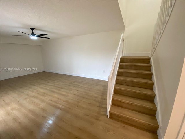120 Heritage Way, West Palm Beach, FL 33407 - staircase featuring wood finished floors, a ceiling fan, and baseboards