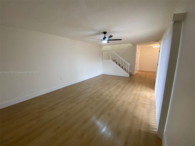 120 Heritage Way, West Palm Beach, FL 33407 - unfurnished living room featuring wood finished floors, ceiling fan, and baseboards