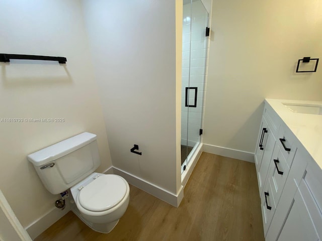 120 Heritage Way, West Palm Beach, FL 33407 - full bathroom featuring wood finished floors, toilet, a stall shower, vanity, and baseboards