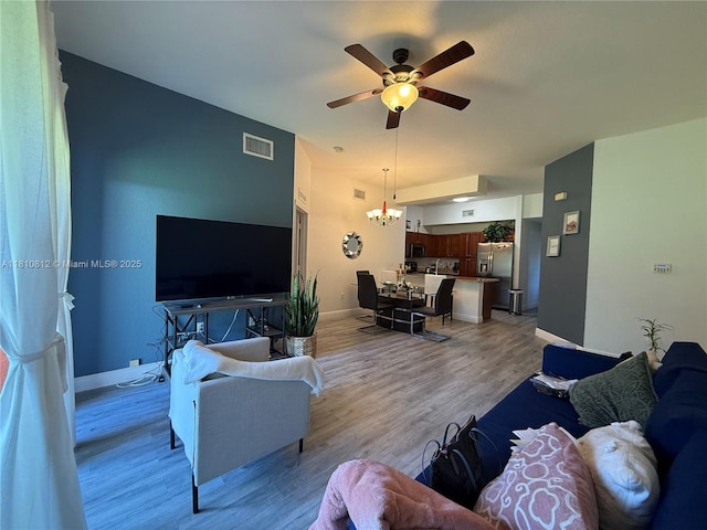 3340 Palomino Dr Unit 211-2, Davie, FL 33024 - living area featuring a ceiling fan, a chandelier, light wood finished floors, and baseboards