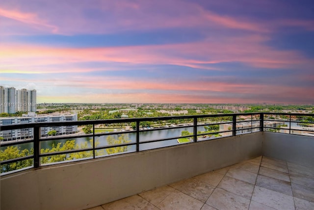 500 Three Islands Blvd Unit 1112, Hallandale Beach, FL 33009 - balcony at dusk featuring a water view and a view of city