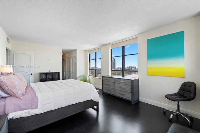 500 Three Islands Blvd Unit 1112, Hallandale Beach, FL 33009 - bedroom featuring baseboards, a textured ceiling, and dark wood-style floors