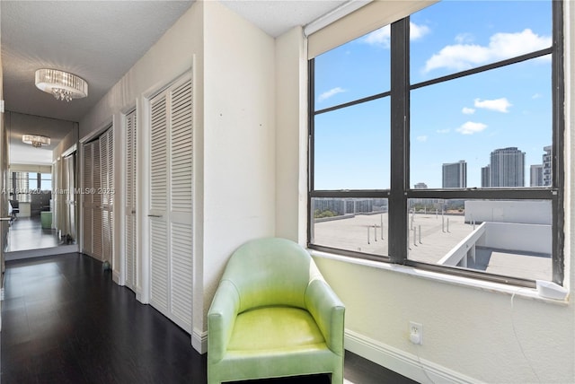 500 Three Islands Blvd Unit 1112, Hallandale Beach, FL 33009 - sitting room with baseboards and wood finished floors