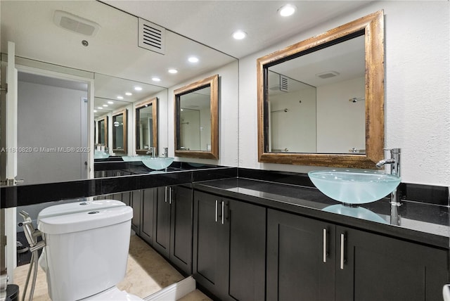 500 Three Islands Blvd Unit 1112, Hallandale Beach, FL 33009 - full bath with double vanity, toilet, recessed lighting, and a textured wall