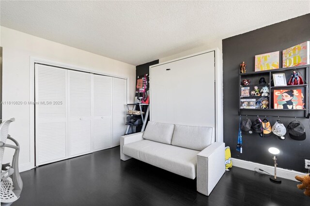 500 Three Islands Blvd Unit 1112, Hallandale Beach, FL 33009 - sitting room with wood finished floors, baseboards, and a textured ceiling
