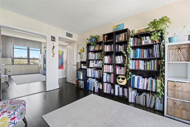 500 Three Islands Blvd Unit 1112, Hallandale Beach, FL 33009 - living area featuring a textured ceiling, baseboards, and wood finished floors