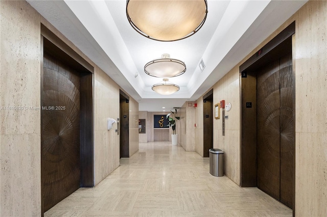 500 Three Islands Blvd Unit 1112, Hallandale Beach, FL 33009 - hallway featuring elevator and a raised ceiling