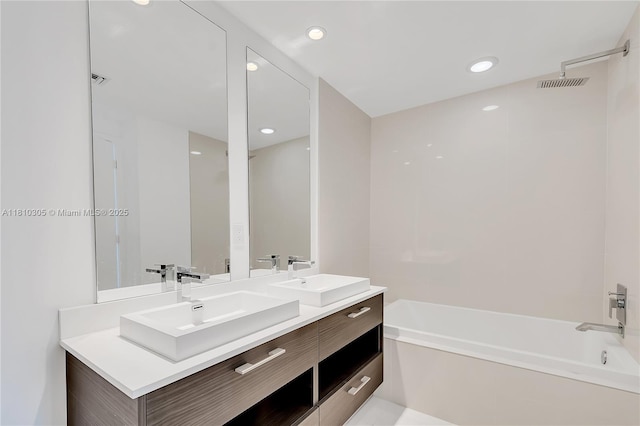 45 SW 9th St Unit 2105, Miami, FL 33130 - bathroom featuring double vanity, bathing tub / shower combination, and recessed lighting