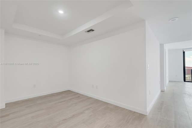 45 SW 9th St Unit 2105, Miami, FL 33130 - unfurnished room with light wood-style floors, a raised ceiling, baseboards, and recessed lighting