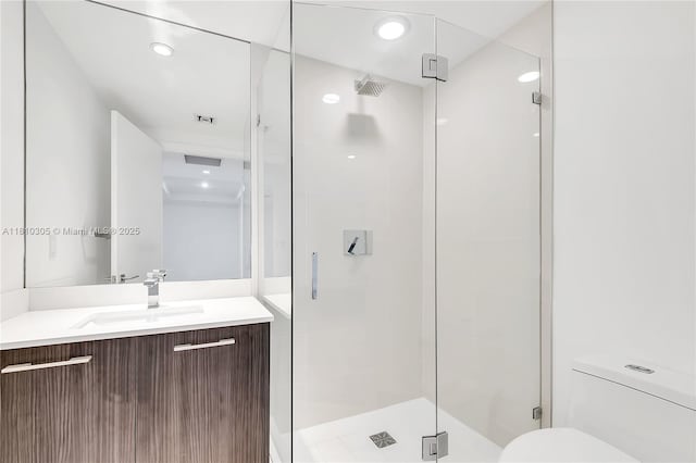 45 SW 9th St Unit 2105, Miami, FL 33130 - bathroom featuring vanity, a shower stall, toilet, and recessed lighting