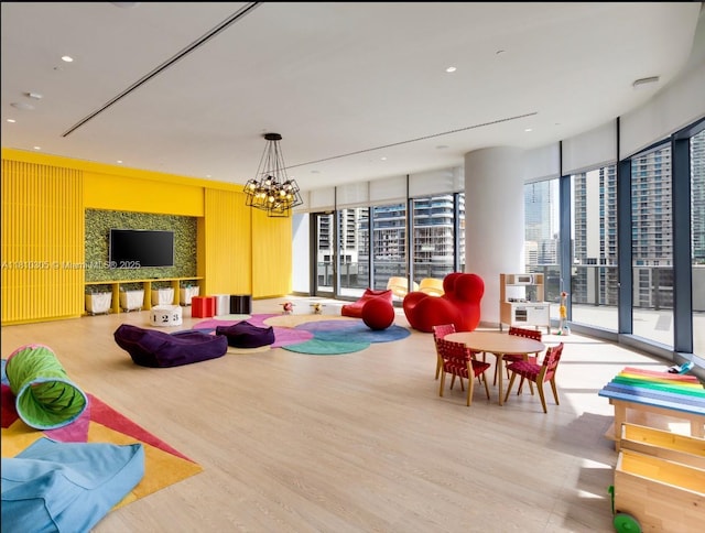 45 SW 9th St Unit 2105, Miami, FL 33130 - playroom with wood finished floors, a chandelier, recessed lighting, and floor to ceiling windows