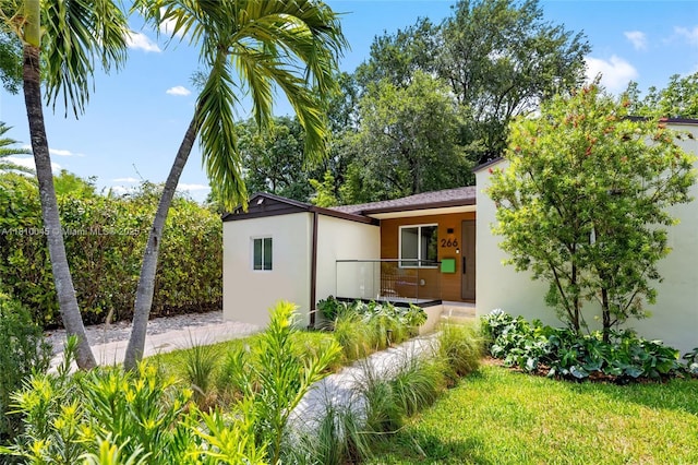 266 NW 42nd St, Miami, FL 33127 - view of side of home featuring stucco siding and covered porch