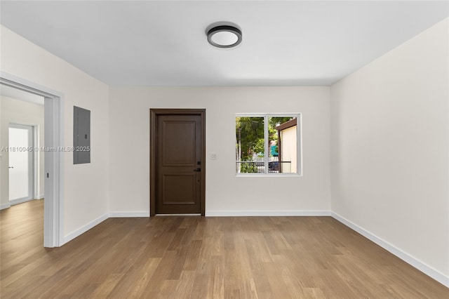 266 NW 42nd St, Miami, FL 33127 - spare room featuring electric panel, wood finished floors, and baseboards