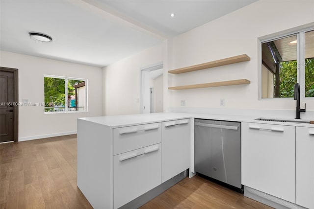 266 NW 42nd St, Miami, FL 33127 - kitchen featuring dishwasher, a sink, modern cabinets, a peninsula, and light countertops