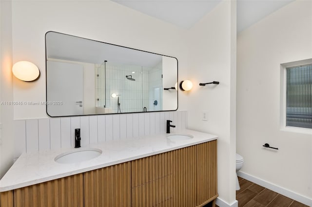 266 NW 42nd St, Miami, FL 33127 - bathroom featuring toilet, a tile shower, double vanity, wood finished floors, and backsplash