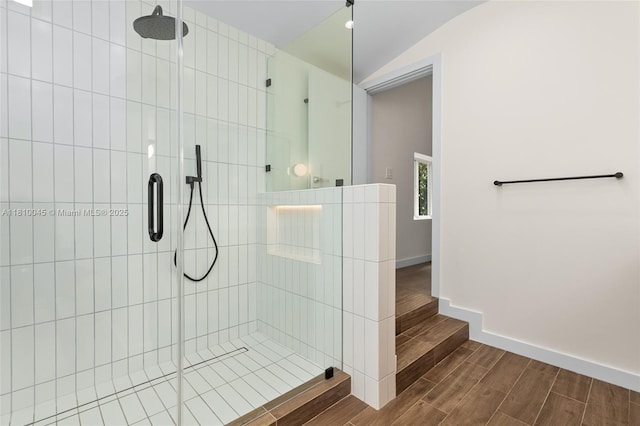 266 NW 42nd St, Miami, FL 33127 - bathroom with a tile shower, wood tiled floors, baseboards, and vaulted ceiling
