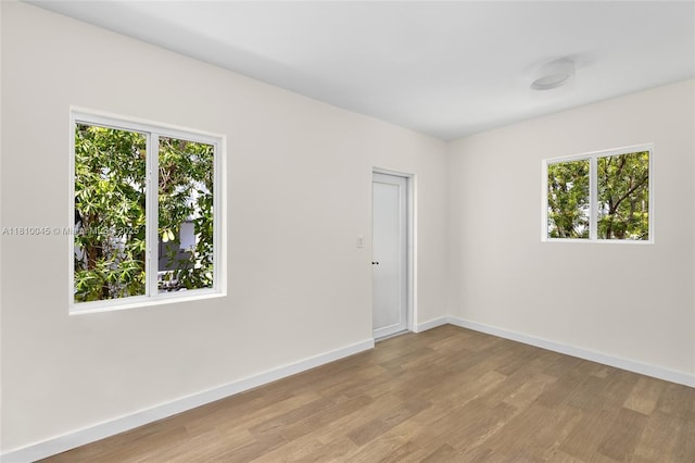 266 NW 42nd St, Miami, FL 33127 - empty room with wood finished floors and baseboards