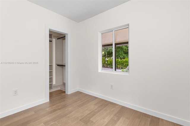 266 NW 42nd St, Miami, FL 33127 - unfurnished bedroom with baseboards and light wood-type flooring