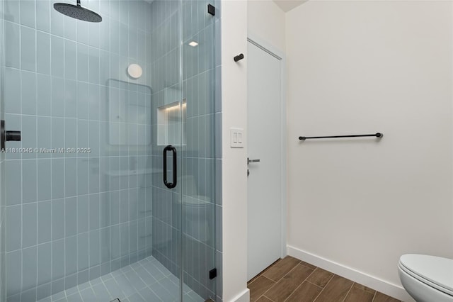 266 NW 42nd St, Miami, FL 33127 - bathroom featuring a stall shower, toilet, wood finished floors, and baseboards