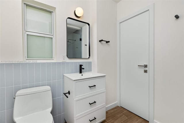 266 NW 42nd St, Miami, FL 33127 - full bath with vanity, wood finished floors, toilet, wainscoting, and tile walls
