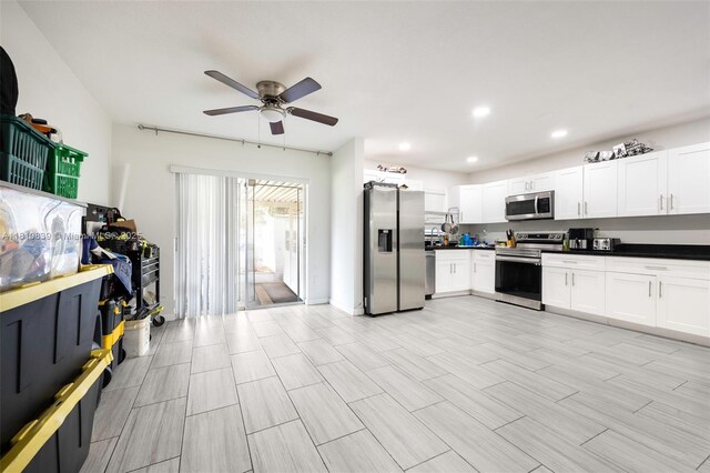 3430 N 65th Ave, Hollywood, FL 33024 - kitchen featuring stainless steel appliances, a ceiling fan, white cabinetry, dark countertops, and recessed lighting