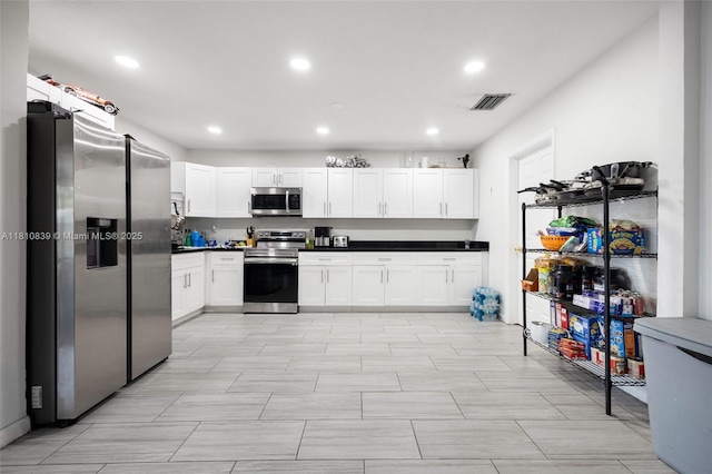 3430 N 65th Ave, Hollywood, FL 33024 - kitchen with stainless steel appliances, recessed lighting, dark countertops, and white cabinets
