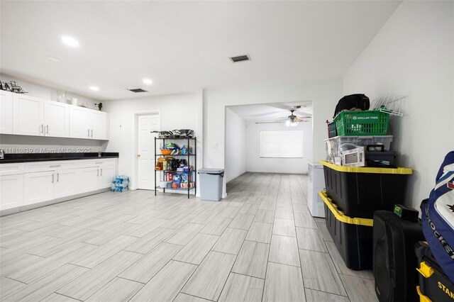 3430 N 65th Ave, Hollywood, FL 33024 - kitchen with ceiling fan, white cabinets, dark countertops, recessed lighting, and light wood-style floors