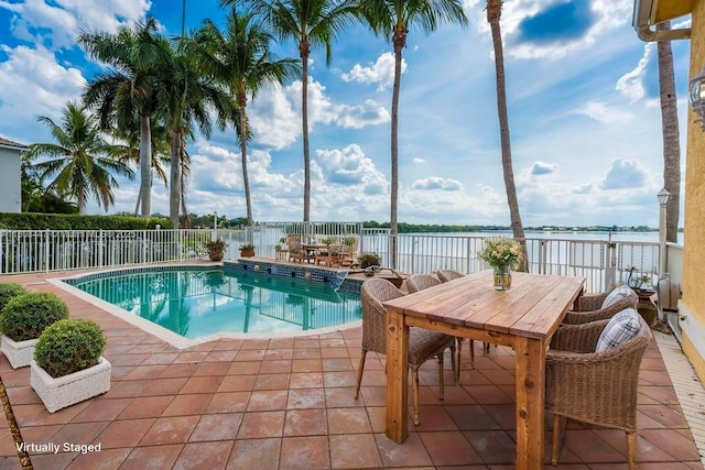 4506 SW 186th Way, Miramar, FL 33029 - view of swimming pool with a water view, outdoor dining space, and a patio