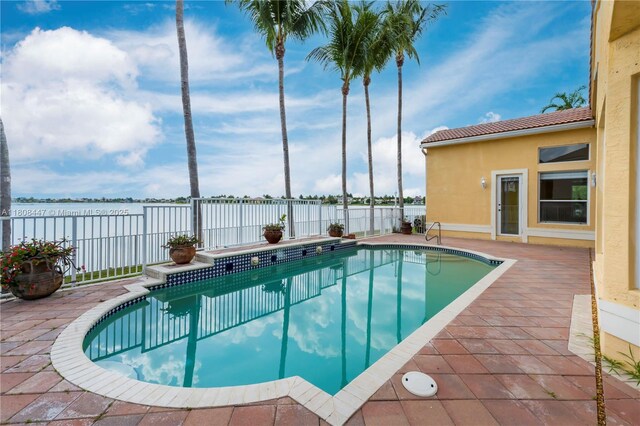 4506 SW 186th Way, Miramar, FL 33029 - view of swimming pool featuring a water view, a fenced backyard, and a patio area