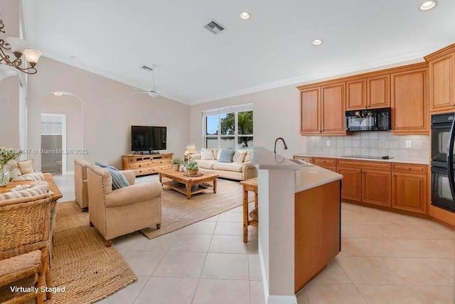 4506 SW 186th Way, Miramar, FL 33029 - kitchen featuring open floor plan, black appliances, tasteful backsplash, light countertops, and vaulted ceiling