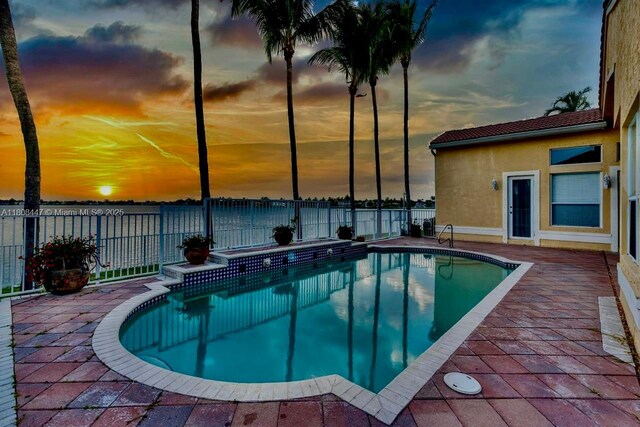 4506 SW 186th Way, Miramar, FL 33029 - pool at dusk featuring a fenced backyard and a water view