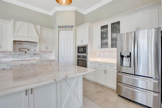15122 SW 34th St, Davie, FL 33331 - kitchen with black appliances, custom exhaust hood, white cabinetry, decorative backsplash, and ornamental molding