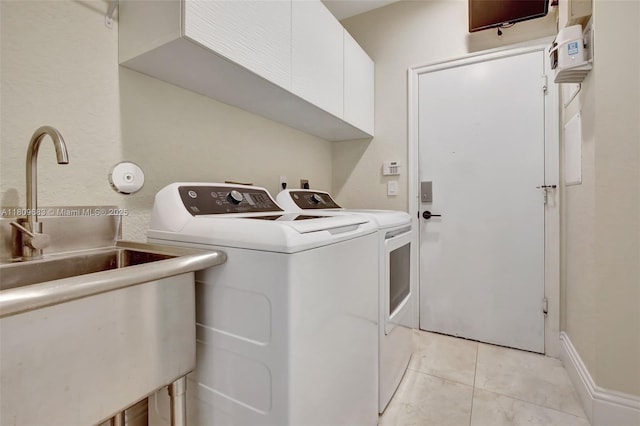 15122 SW 34th St, Davie, FL 33331 - laundry area featuring separate washer and dryer, cabinet space, and light tile patterned floors